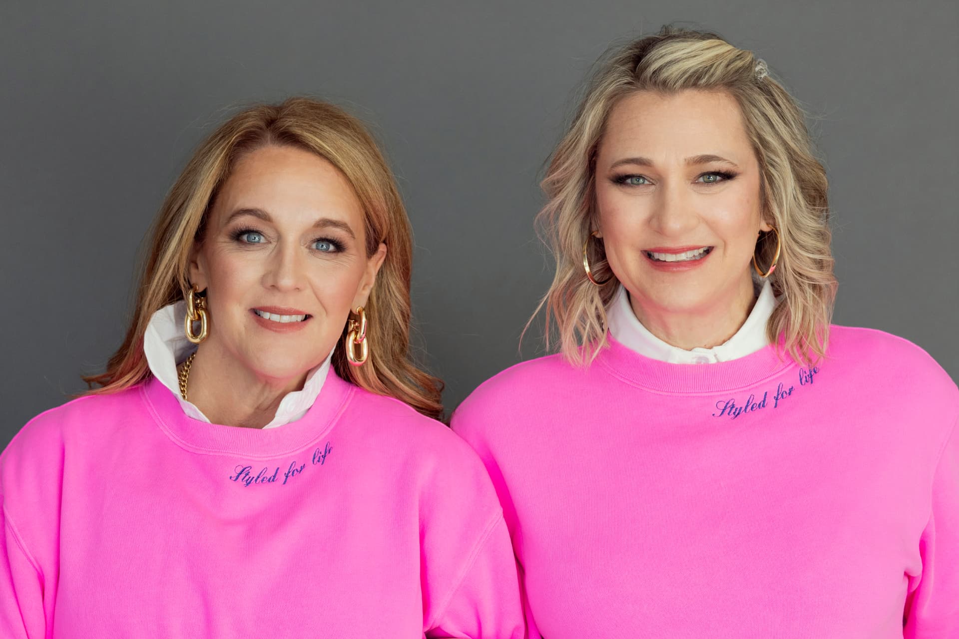 Kristen Campbell and Kristin Argento wearing pink Styled for Life sweatshirts